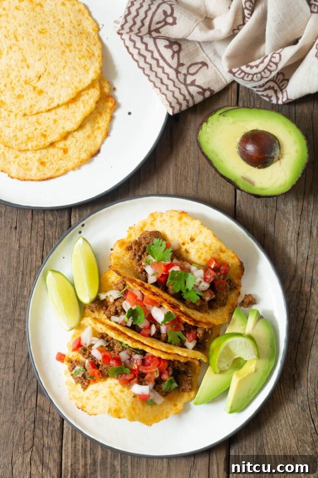 low-carb-tortillas Overhead shot of three tacos on a plate made with low carb tortillas, vibrant with fresh toppings.