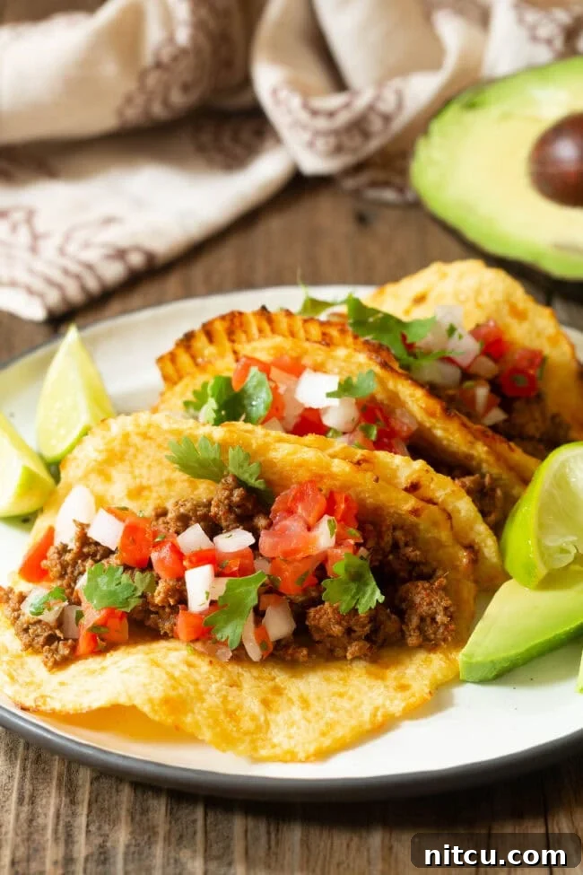Keto Low Carb Tortillas Recipe 2 Low Carb Tortillas with various taco fillings arranged appealingly on a plate.