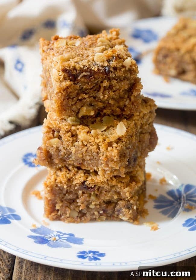 Wholesome Eggless Oat Bars 11 Stack of egg-free oatmeal bars on a clean white plate, ready to be served.