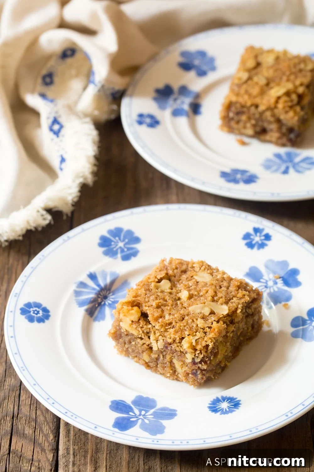 Wholesome Eggless Oat Bars 4 Homemade egg-free oatmeal bars arranged on a charming blue and white patterned plate.