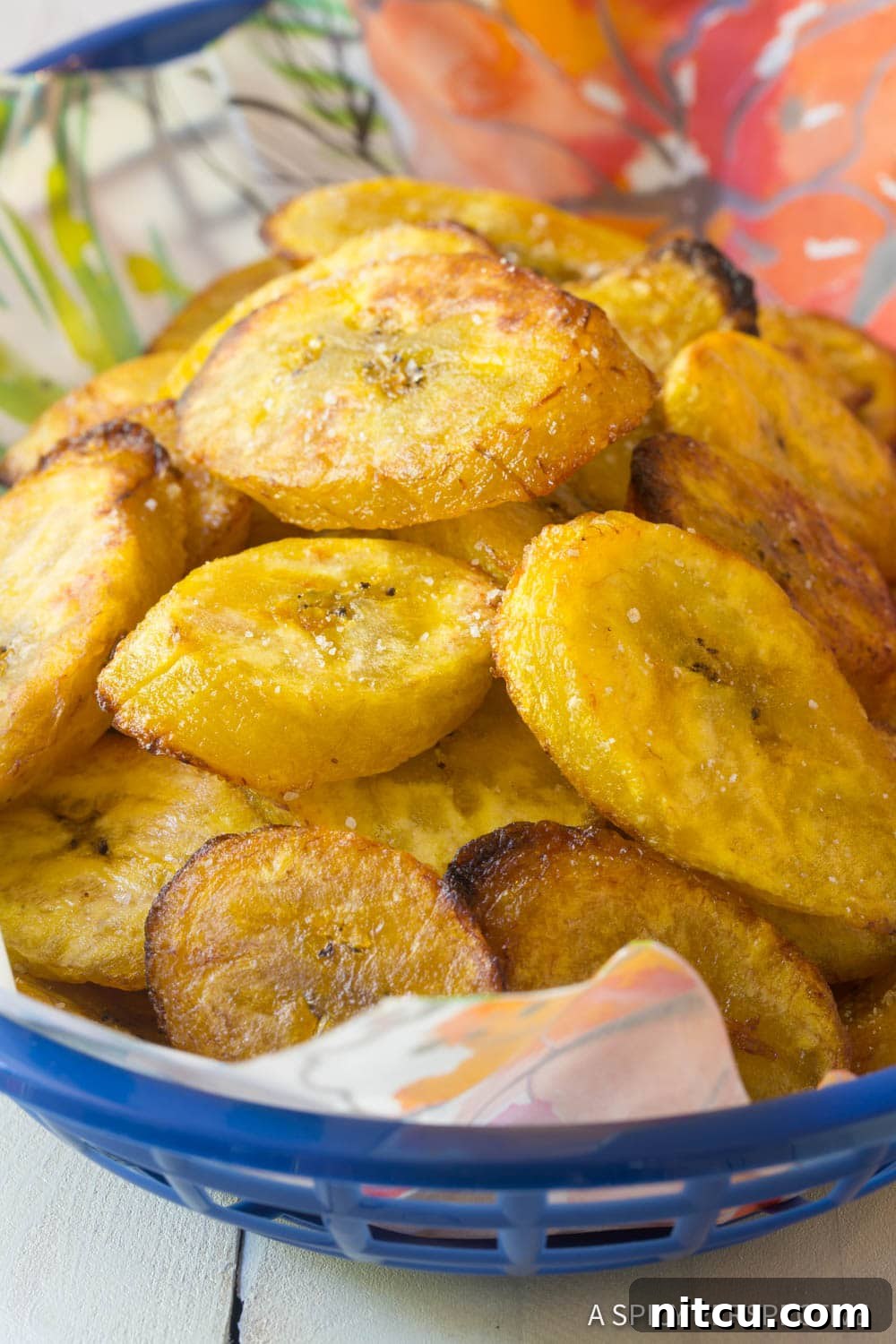 Golden Baked Plantains 2 A rustic basket overflowing with golden-brown baked plantains, highlighting their tender texture and slightly crisp edges.