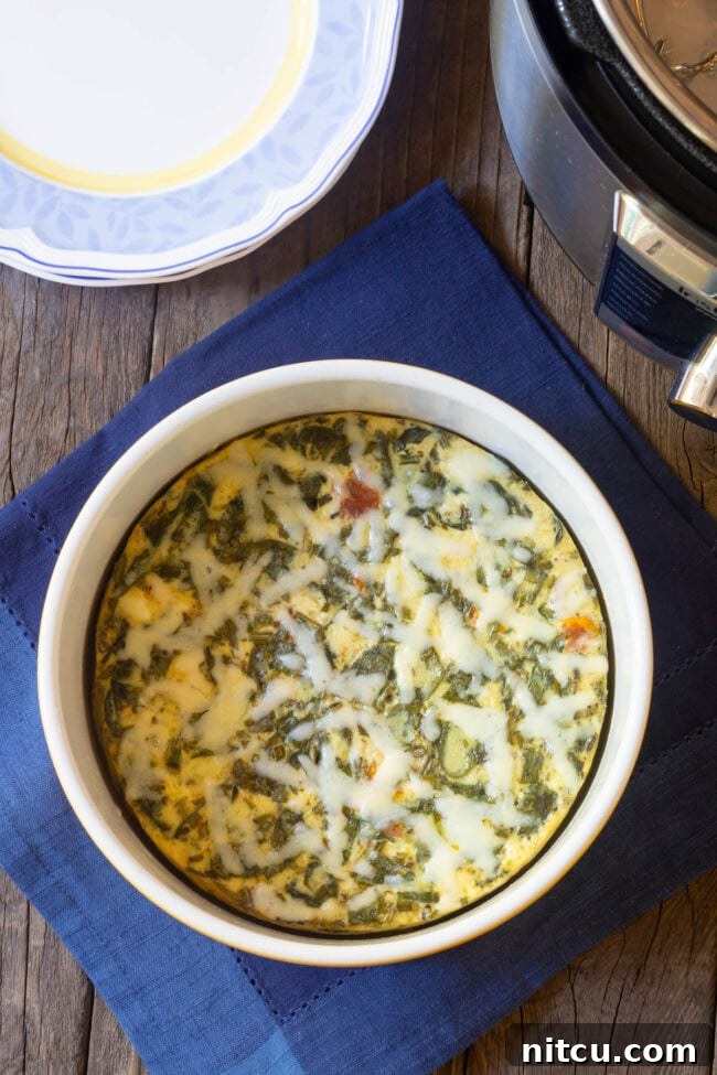 Simple Instant Pot Keto Crustless Quiche 2 Overhead shot of crustless quiche in a souffle pan, freshly cooked and golden brown.
