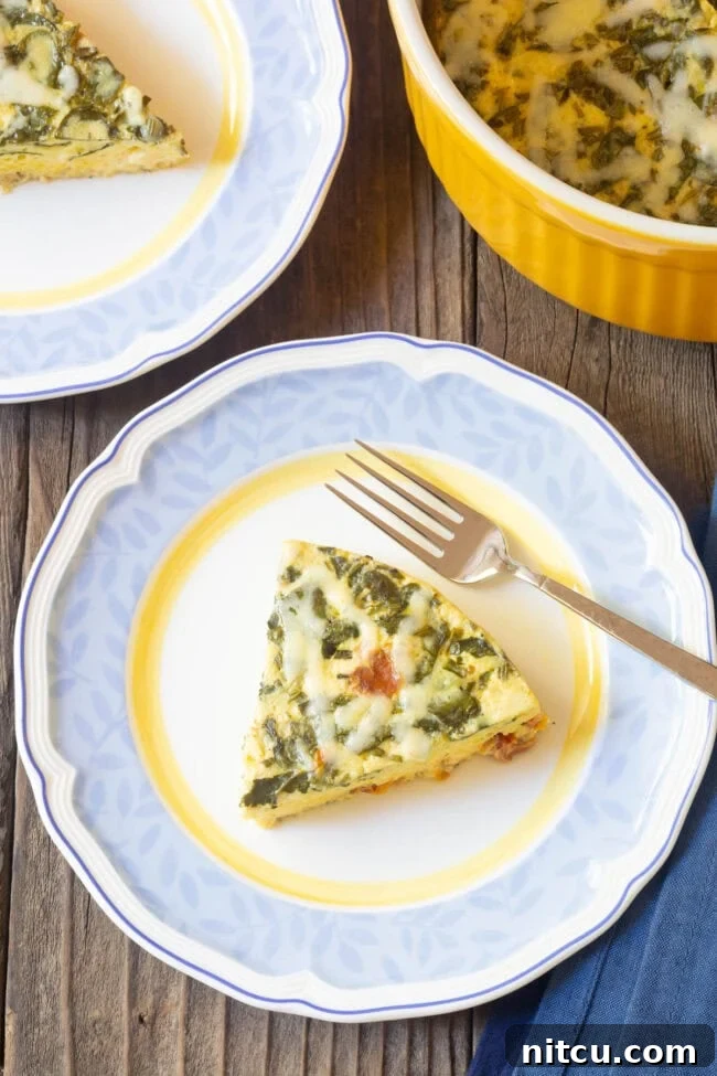 Simple Instant Pot Keto Crustless Quiche 3 A perfectly portioned slice of crustless quiche on a pristine white plate, showcasing its fluffy texture and vibrant fillings.