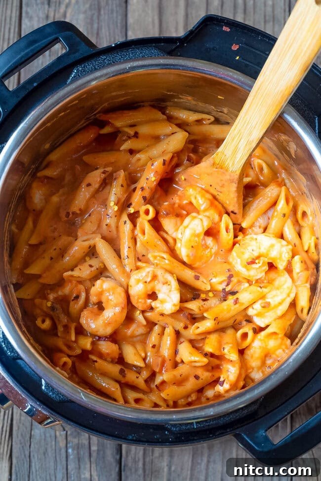 Velvety Instant Pot Vodka Shrimp Pasta 2 Overhead shot of shrimp pasta with vodka sauce in an instant pot.