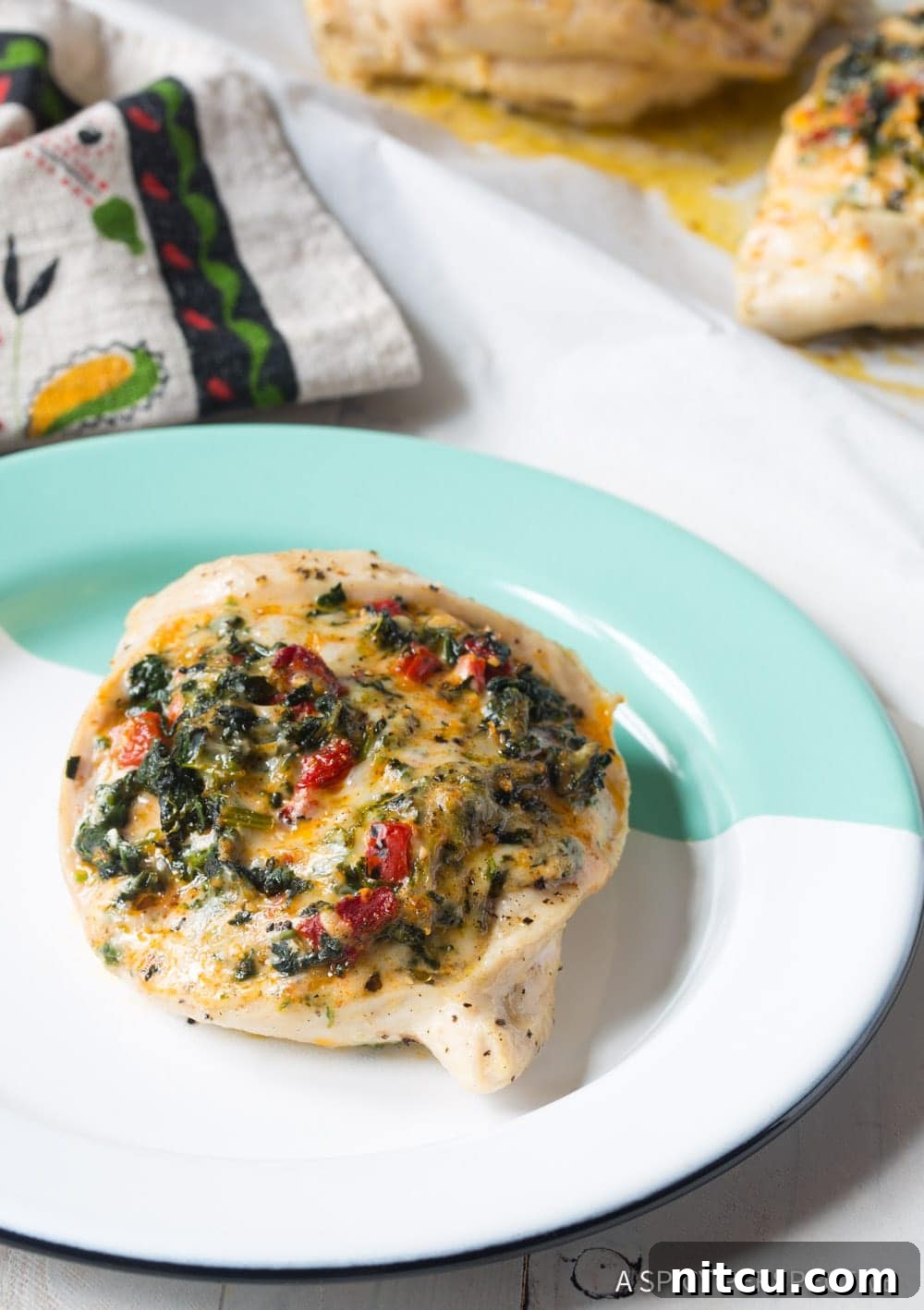 Creamy Spinach-Stuffed Chicken 3 Stuffed chicken breast on a plate.