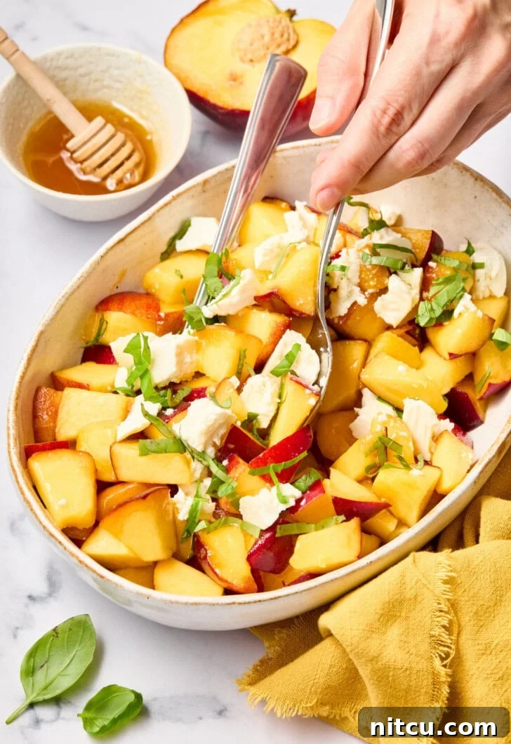 Refreshing Peach and Basil Salad 3 Close-up of vibrant peaches and fresh basil leaves artfully arranged in a salad, highlighting the fresh ingredients.