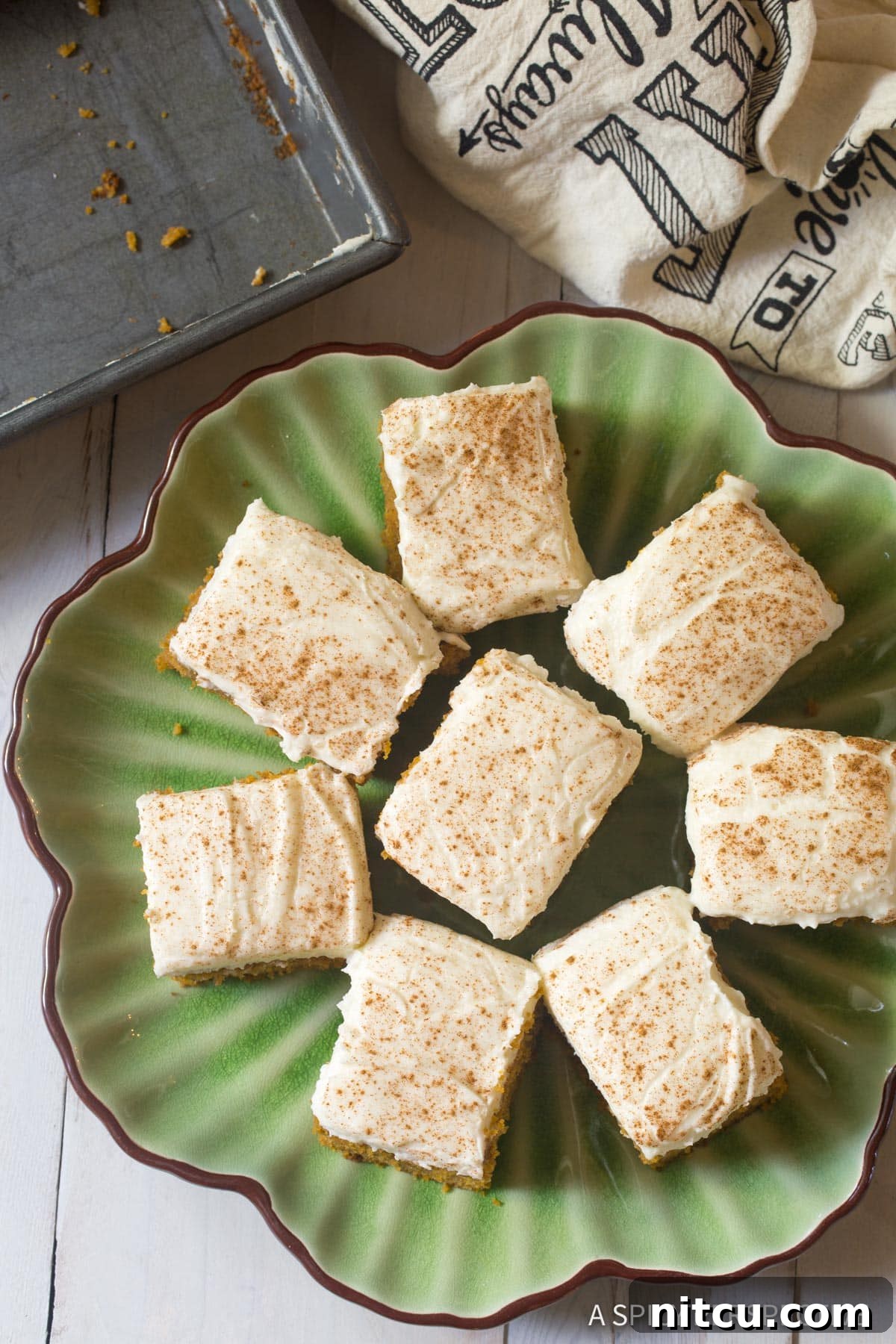 Harvest Pumpkin Slab Cake 4 Overhead shot of perfectly cut pieces of Pumpkin Texas Sheet Cake with Buttermilk Frosting arranged on a platter, ready to serve.
