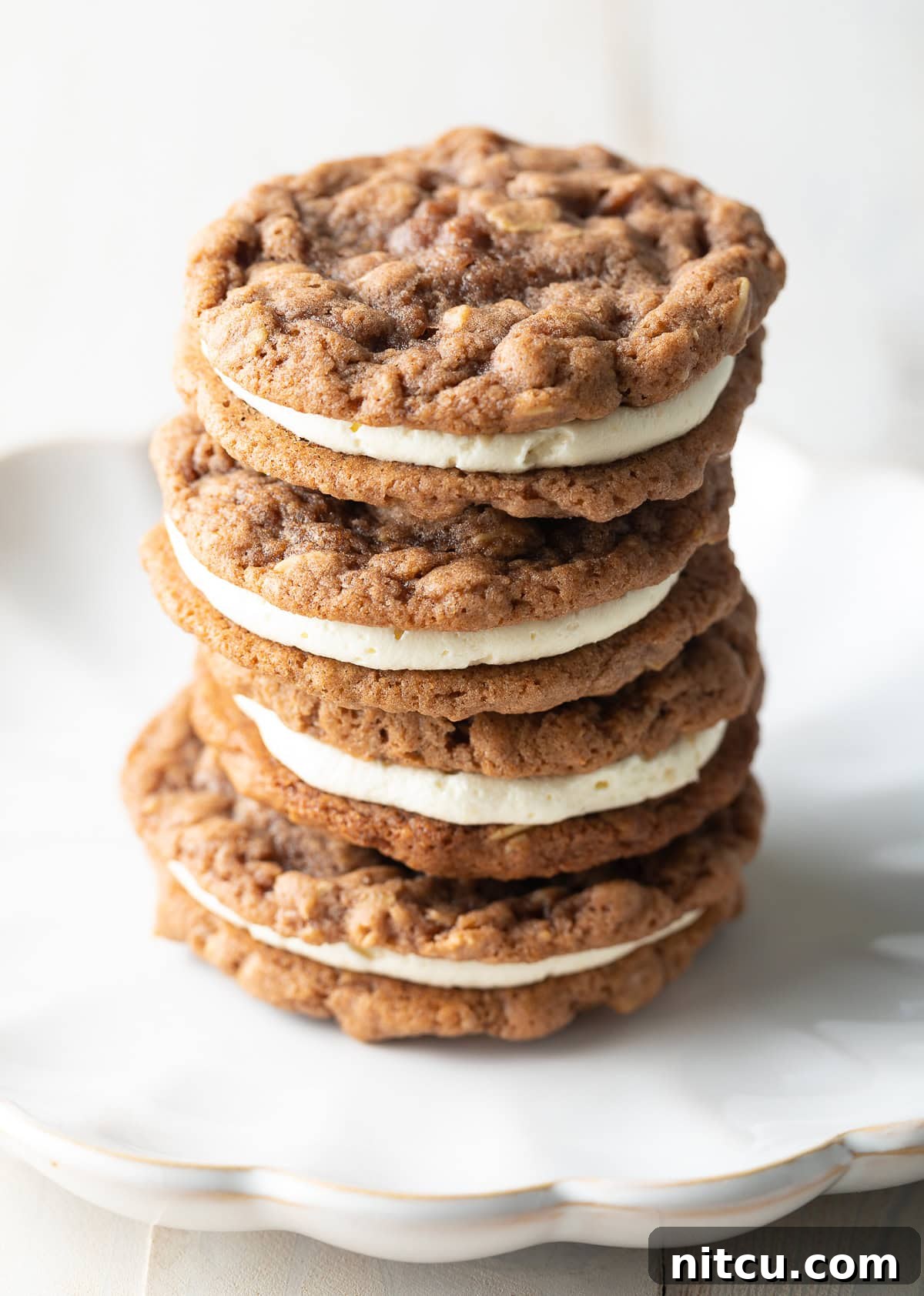 oatmeal cookies Three exquisite homemade oatmeal cream pies stacked on top of each other, ready to be enjoyed.