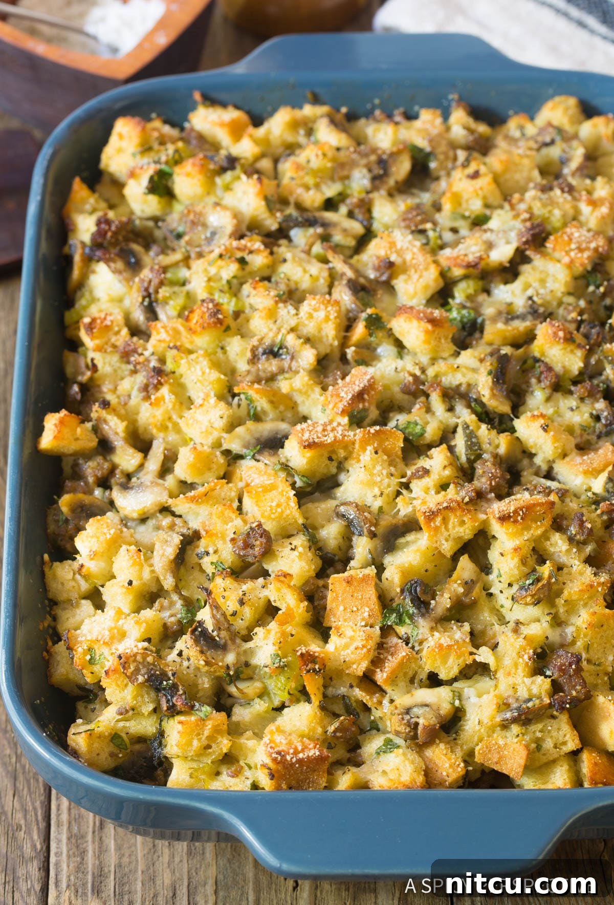 Savory Mushroom and Sausage Dressing 3 Sausage Mushroom Thanksgiving Stuffing Recipe in casserole dish with golden brown top.