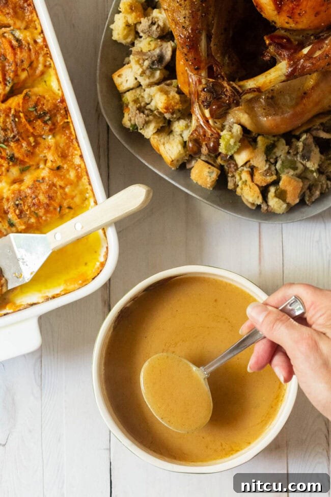 Elevated Turkey Gravy 3 Homemade Turkey Gravy Recipe -overhead shot with Thanksgiving sides.
