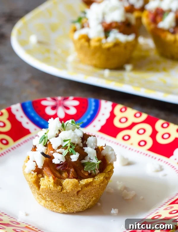 Bite-sized Tamales 4 A plate of freshly baked Mini Tamales, generously topped with crumbled cheese and ready to serve.