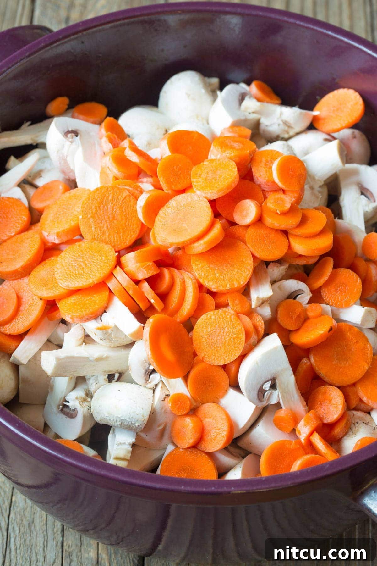 Hearty Beef Stew Perfection 4 Chopped vegetables, beef, and broth simmering together in a pot.