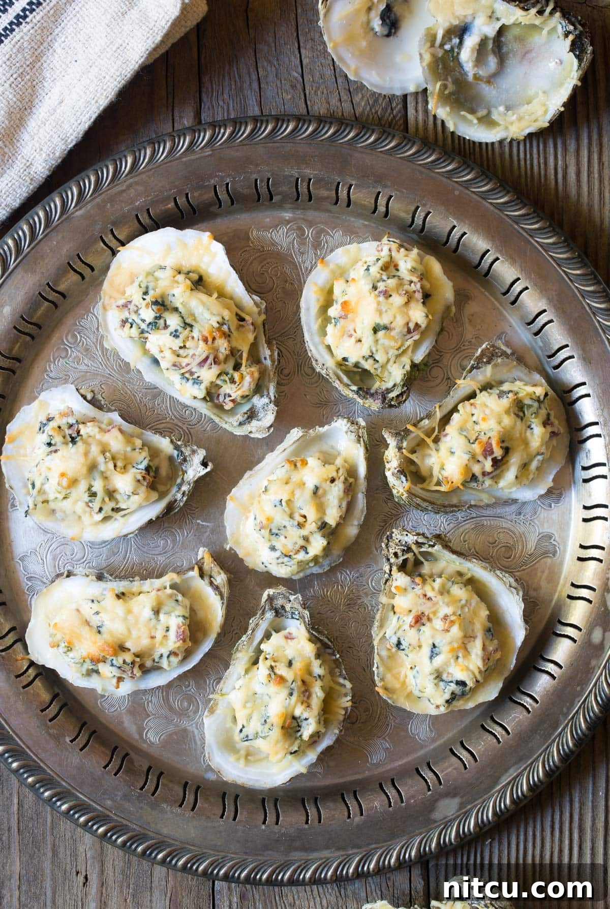 Baked Oysters Fromage 3 Overhead view of cheesy baked oysters on the half shell, arranged on a baking tray