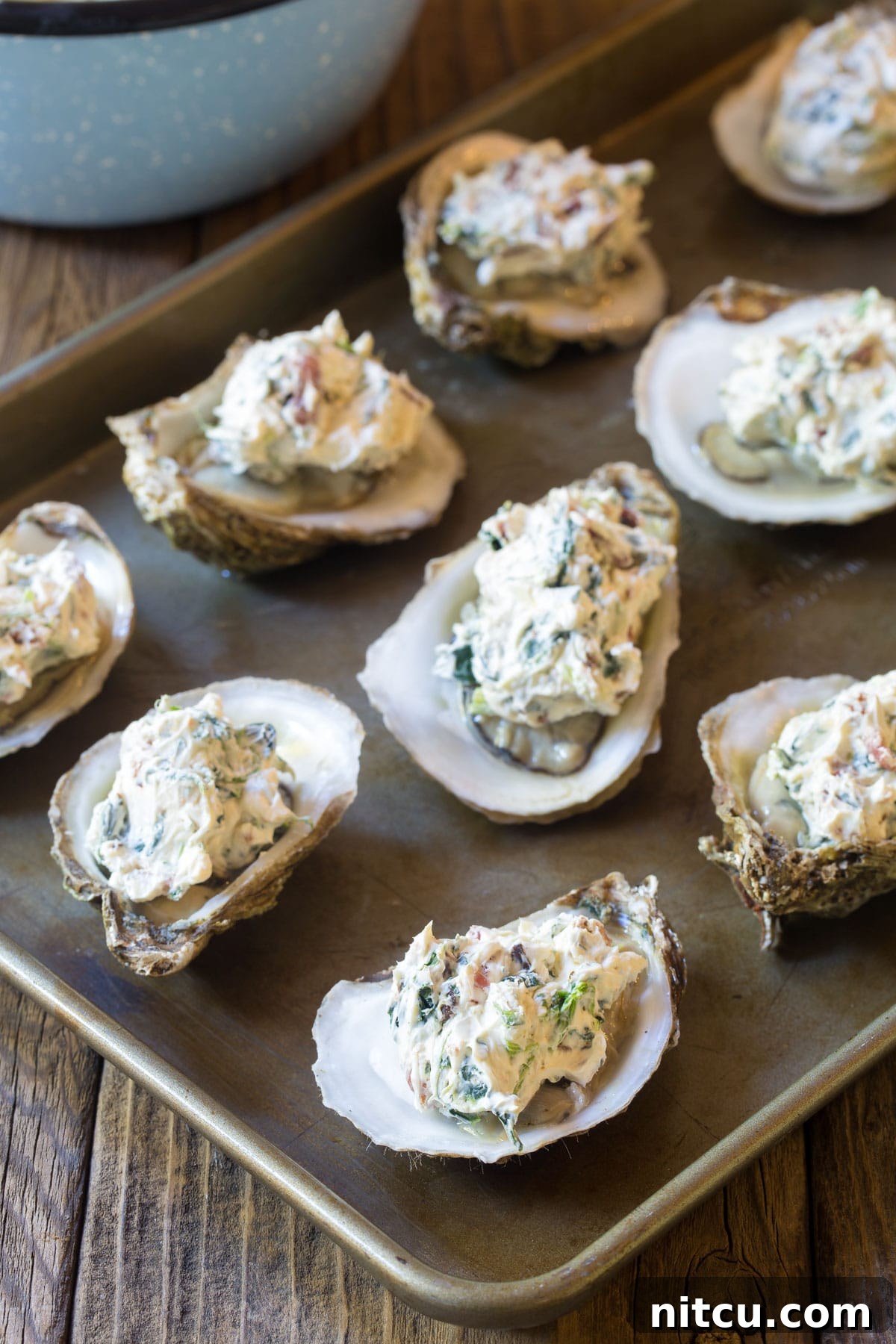 Baked Oysters Fromage 6 A tray of oysters with the three-cheese filling ready for baking in the oven