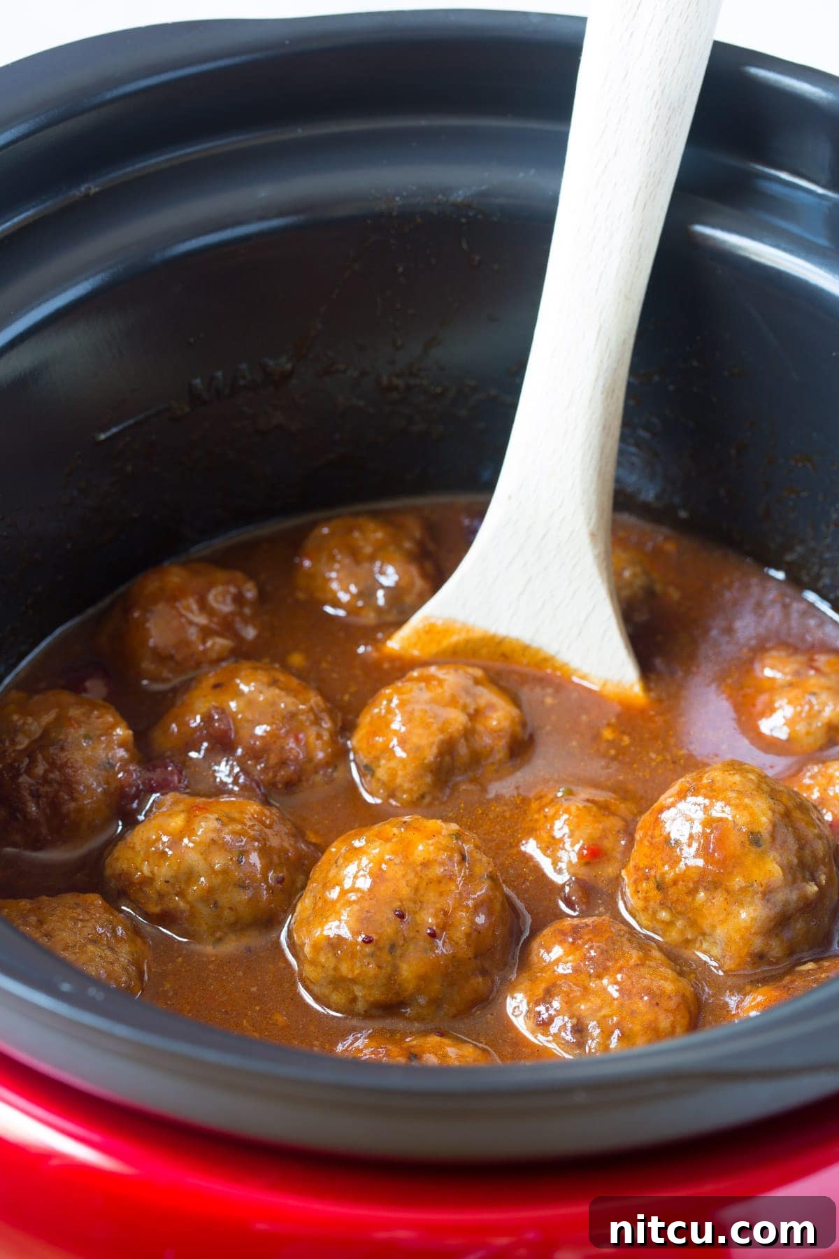 Crockpot Party Meatballs 4 Crock pot cocktail meatballs simmering gently in their sweet and spicy sauce
