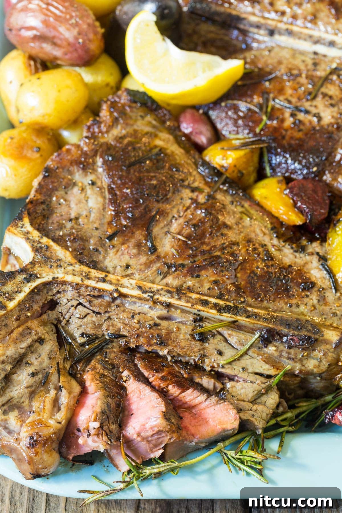 Close-up shot of perfectly cooked Florentine Steak, sliced and arranged on a platter with herbs