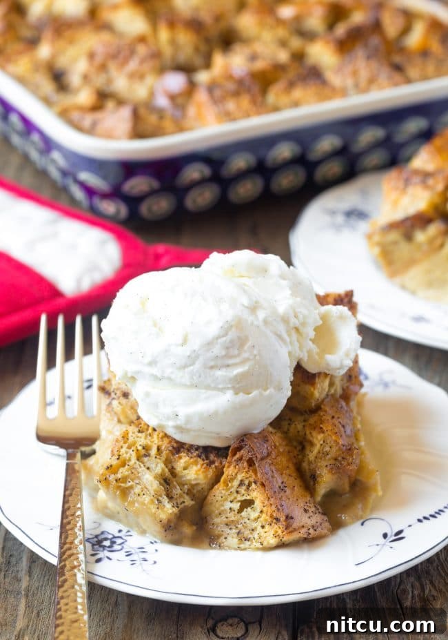 Espresso Bread Pudding Bliss 9 Piece of bread pudding topped with a scoop of ice cream on a white plate.