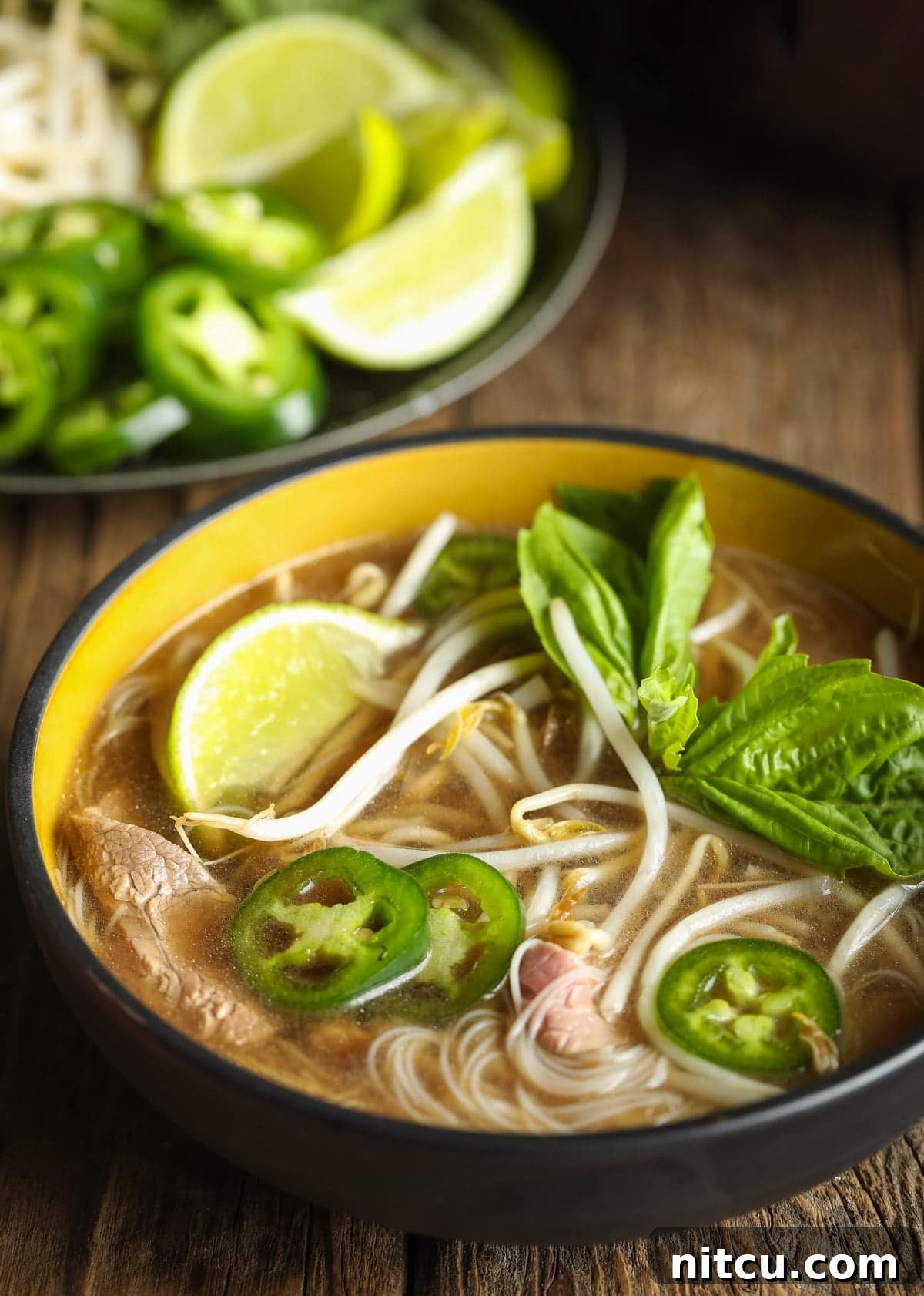 Wholesome Pho Creation 3 Close-up shot of rich pho broth with translucent low-carb noodles in a black bowl, ready for garnishes.
