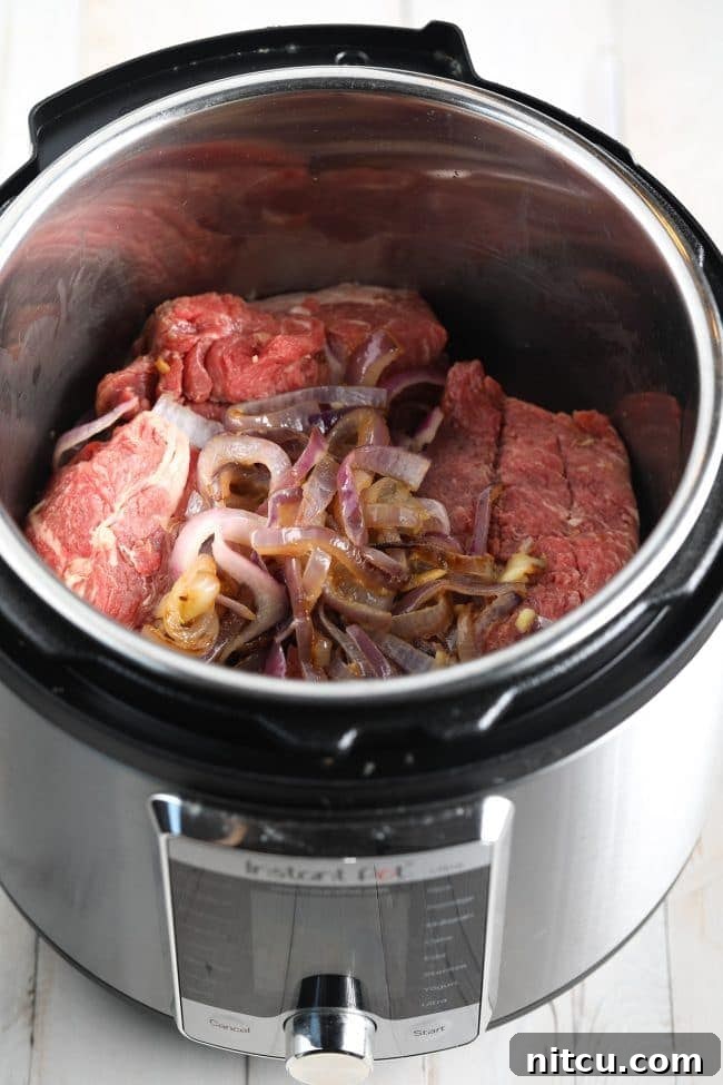 Savory Italian Beef 7 Sautéed onions and garlic with beef in the Instant Pot before pressure cooking.