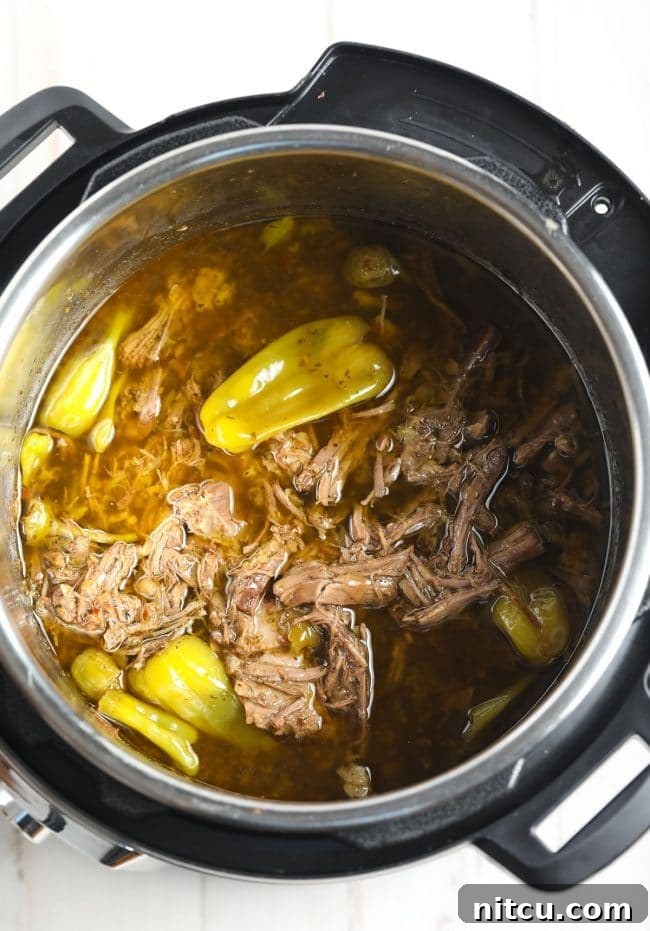 Savory Italian Beef 9 Shredded Low Carb Instant Pot Italian Beef with cooking juices in the pot.