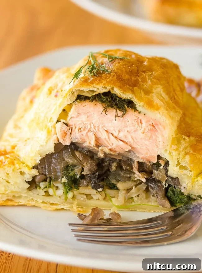 Regal Salmon Pie 2 Exquisite Salmon Coulibiac, also known as Salmon Wellington, sliced open to reveal its beautifully crafted layers of salmon, rice, and mushrooms.