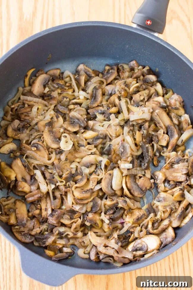 Regal Salmon Pie 5 Close-up of golden-brown sautéed mushrooms, perfectly cooked and ready to be layered into the Salmon Coulibiac.