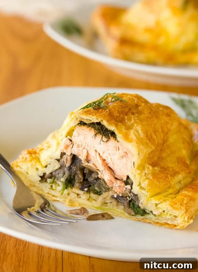 Regal Salmon Pie 10 A stunning Holiday Salmon Wellington (Salmon en Croûte) sliced open to artfully display its rich, layered interior of salmon, rice, and vegetables.