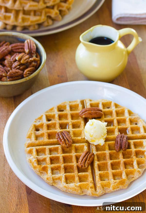 Crispy Spelt Waffles, golden brown and inviting, stacked on a plate.