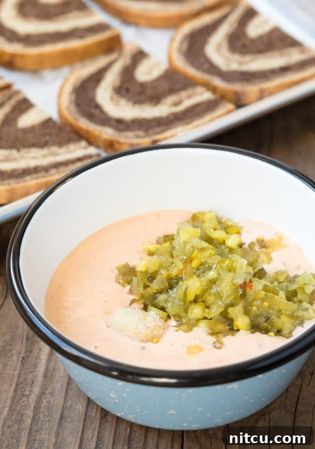 Golden Baked Reuben Sandwich 6 Thousand Island dressing in a small bowl, artfully mixed with horseradish and relish, ready for the sandwiches.