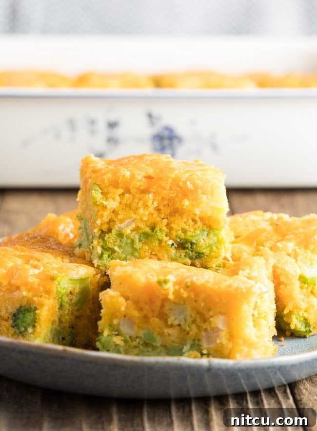 Garden Harvest Cornbread 2 Stacked pieces of fluffy broccoli cornbread, golden-brown and inviting