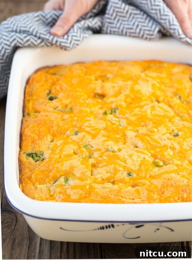 Garden Harvest Cornbread 4 Close-up of a square of fluffy broccoli cornbread with melted cheese