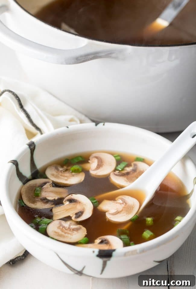 Elegant Dashi Broth 5 Japanese clear soup in a bowl with a large soup spoon.