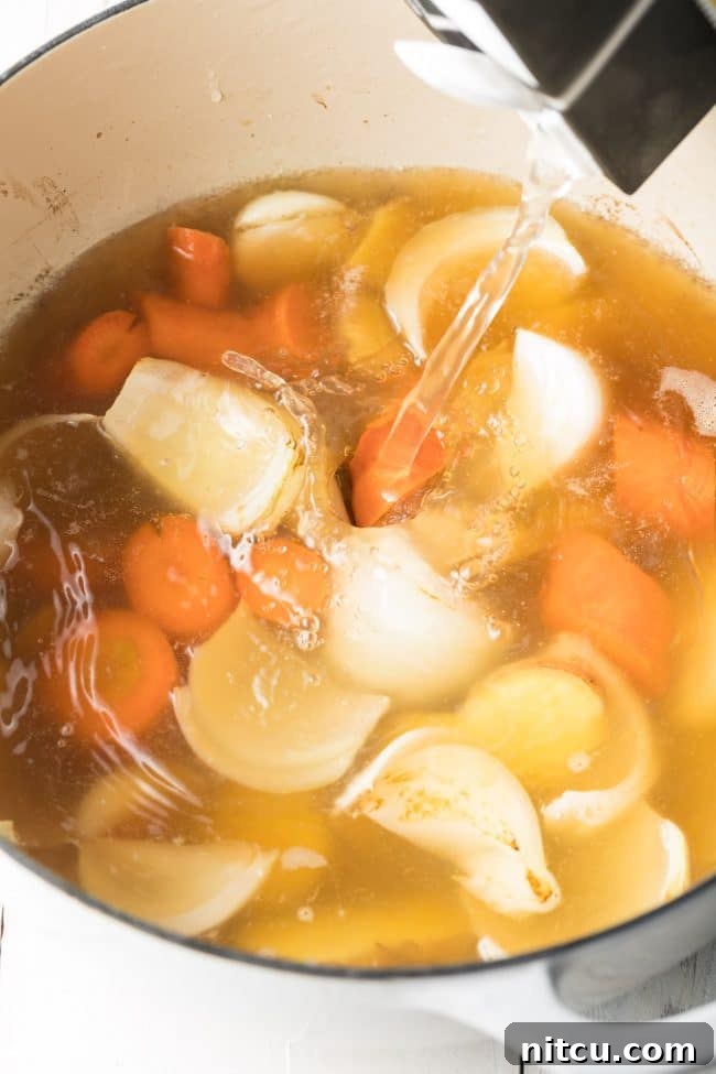 Elegant Dashi Broth 7 Water being poured into the pot over the veggies.