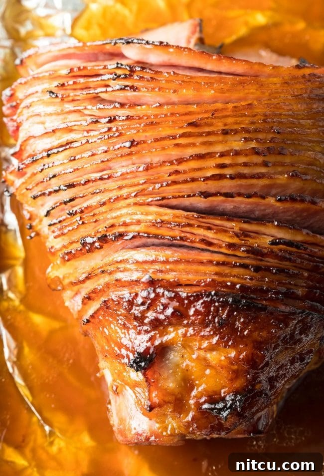 Coca-Cola Uncut 3 Overhead shot of a ham, partially covered in foil, absorbing the Coca-Cola glaze during baking.
