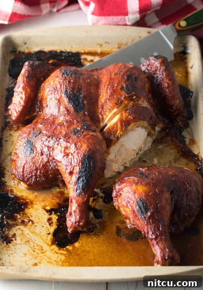 Coca Cola Glazed Spatchcock Chicken 3 Slicing into a perfectly cooked Coca Cola Spatchcock Chicken.