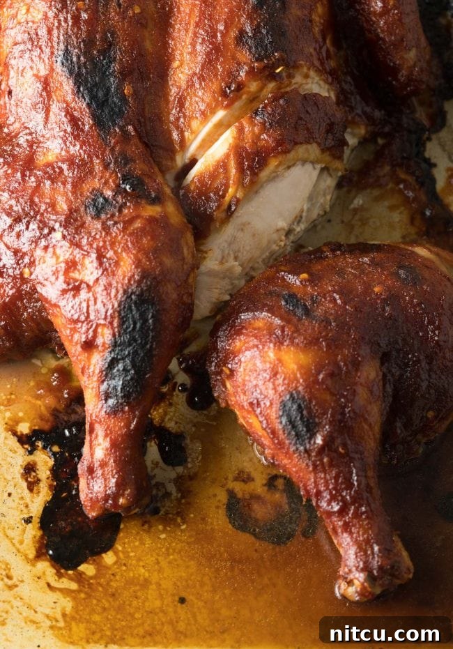 Coca Cola Glazed Spatchcock Chicken 9 Coca cola chicken - partially sliced, showing juicy interior.