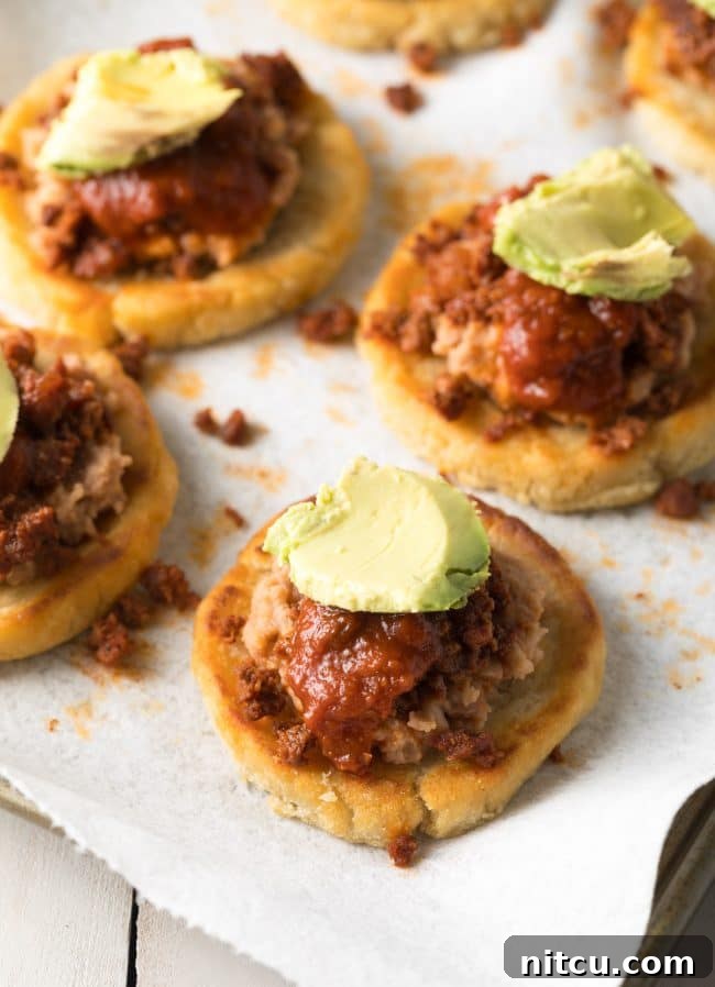 Mexican Sopes with toppings - sauce and avocado