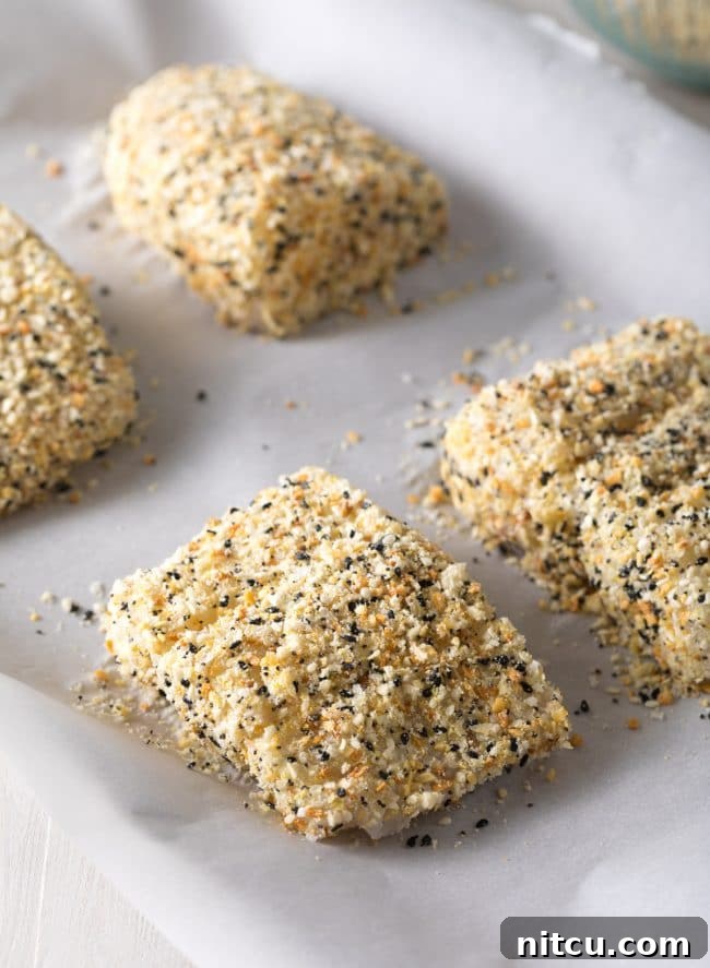 Everything Bagel Crusted Cod 7 Raw white fish on a baking dish with an everything bagel seasoning crust.