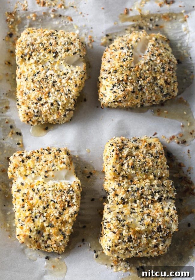 Everything Bagel Crusted Cod 8 Perfect Baked White Fish with Everything Bagel Crust on a baking sheet.