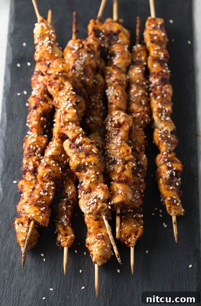 Gochujang Glazed Chicken Skewers 3 Close-up of grilled Korean chicken skewers, glistening with spicy glaze.