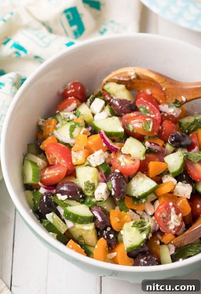 Horiatiki Greek Village Salad 2 Horiatiki (Greek Village Salad) Recipe with fresh tomatoes, cucumbers, feta, and olives, garnished with herbs. #greek #salad #glutenfree #lowcarb #keto #vegetarian