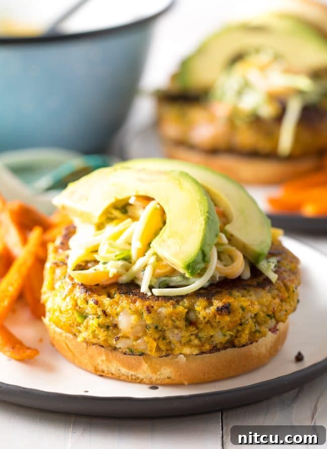 Gourmet Shrimp Burgers 3 Close-up of a Caribbean Shrimp Burger with fresh toppings and mango slaw