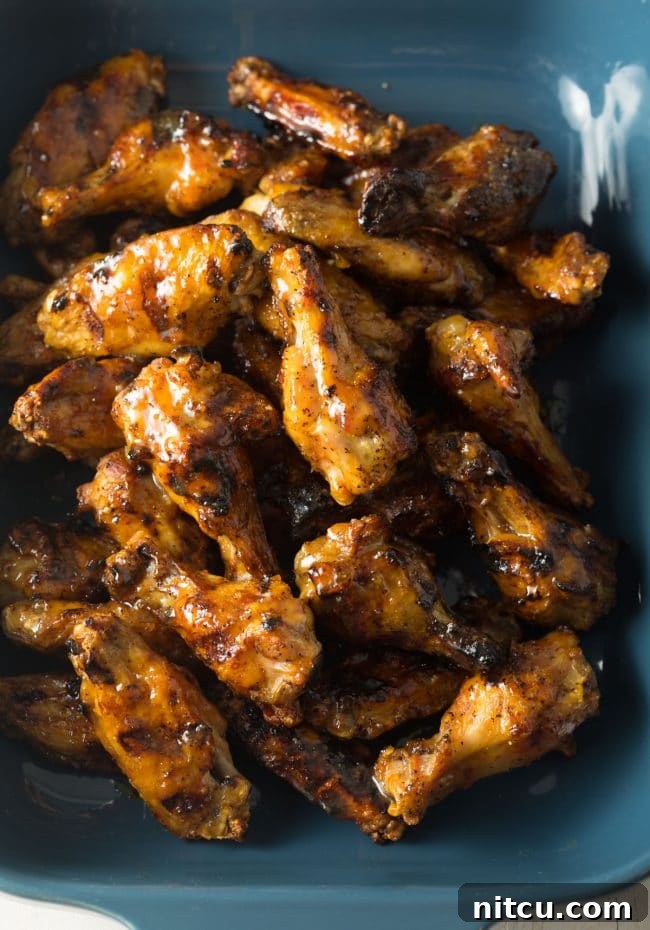 Peach Habanero Flame Wings 3 Blue baking dish loaded with grilled habanero peach chicken wings.