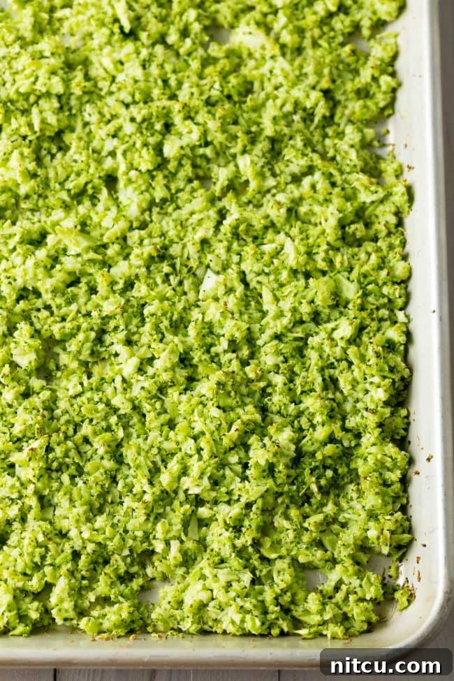 Nutrient-Packed Broccoli Rice 11 Sheet pan filled with freshly roasted riced broccoli, a delicious and healthy rice substitute