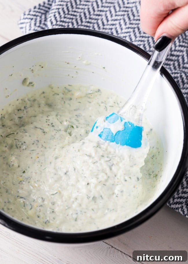 Refreshing Greek Cucumber Dip 7 Mixed ingredients for tzatziki in a bowl.