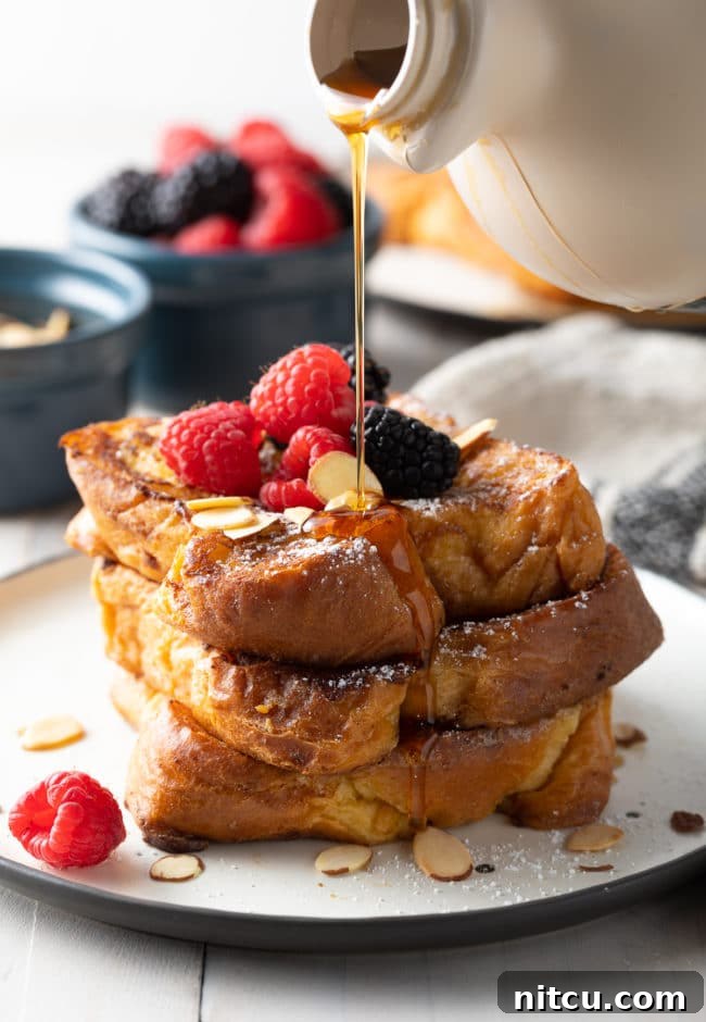 Golden Fluffy French Toast Perfection 2 How To Make Pain Perdu - toast piled high on a white plate.