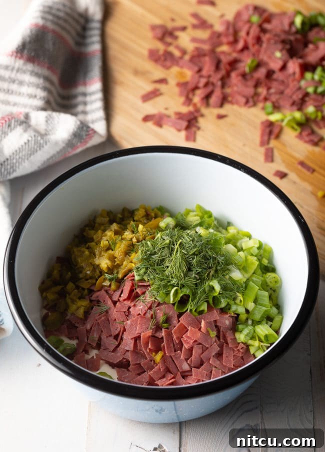 Bowl filled with ingredients for chipped beef dip. 