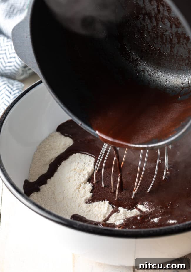 Coffee-Kissed Texas Sheet Cake 3 Pouring cocoa mixture into the flour mixture.
