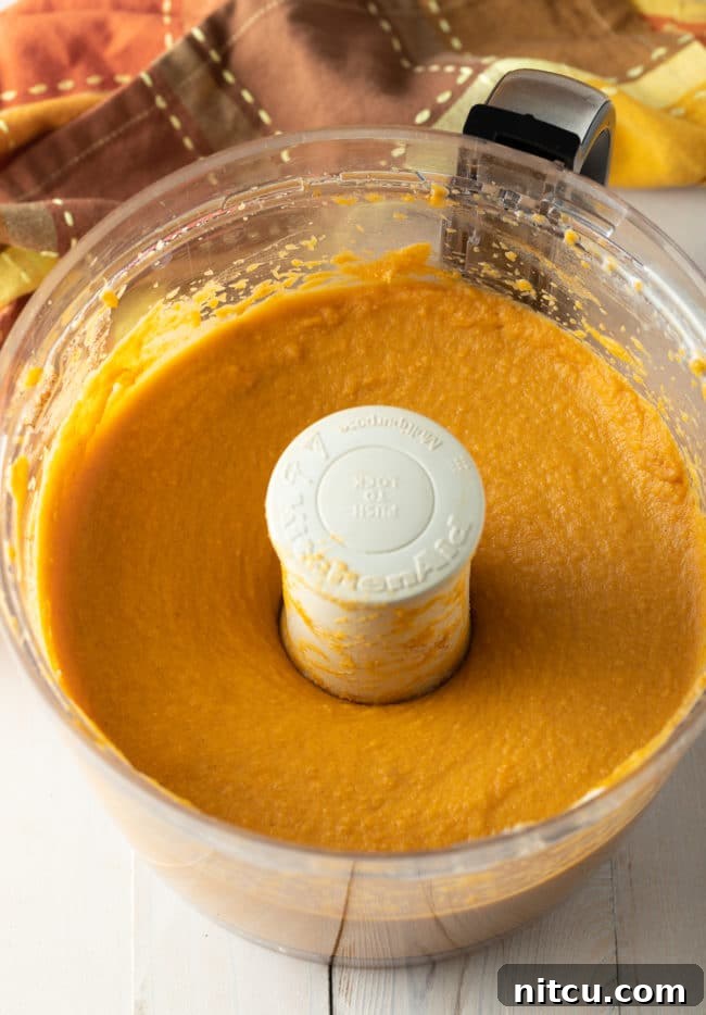 Velvety Southern Sweet Potato Pie Perfection 3 A bowl of creamy sweet potato pie filling, perfectly spiced and smooth, showcasing its readiness to be poured into the pie crust.