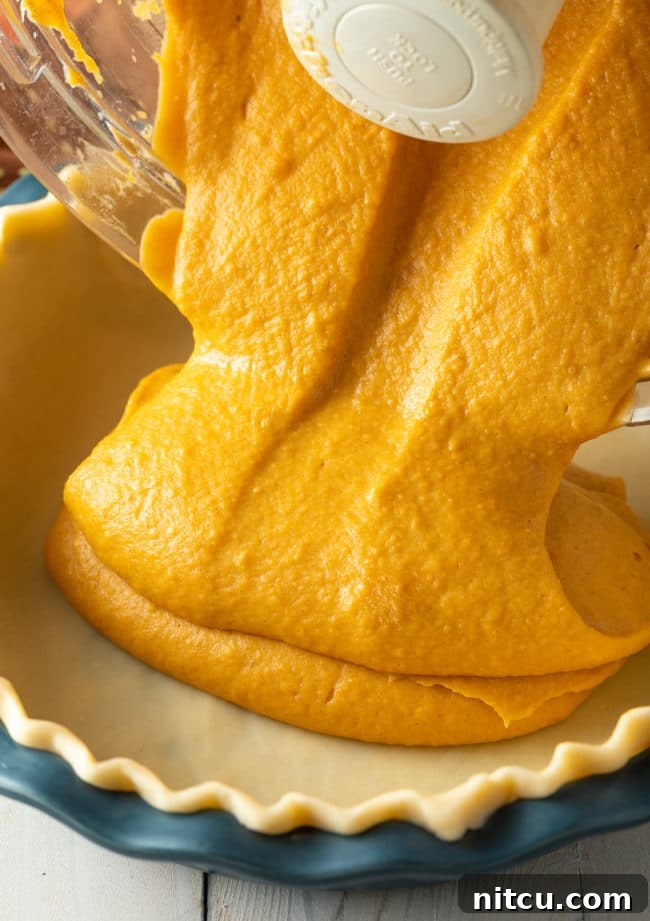 thanksgiving A beautifully baked Thanksgiving sweet potato pie, ready for serving. Its golden-brown crust and smooth filling evoke feelings of warmth and holiday festivity.